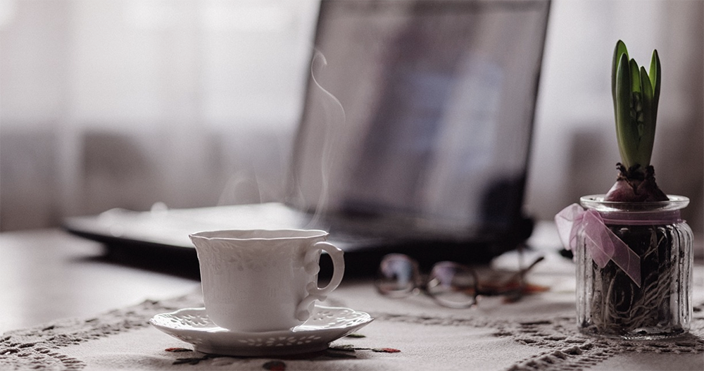 tea next to the computer, work space
